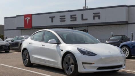 car sitting in the parking lot at a Tesla dealership