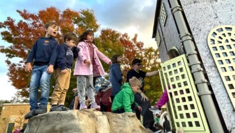 Kids wait to go into the child-sized Fonthill Castle at the new Doylestown playground.