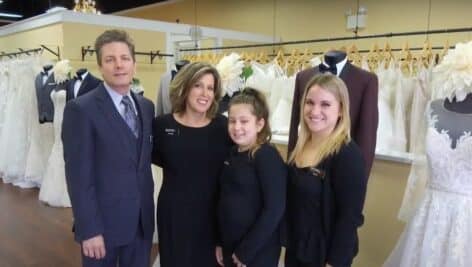 Family of Darianna Bridal & Tuxedo standing in shop