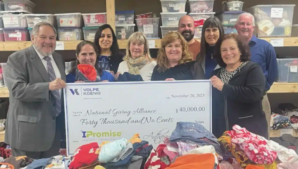 National Giving Alliance holding giant check
