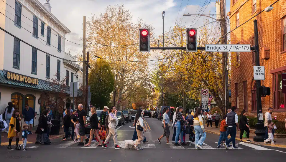 Pedestrians cross Main Street in New Hope, a popular travel desitation where one can find many shops and restaurants within walking distance.