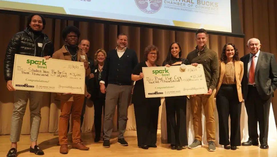 Spark bowl winners and their teams on stage with big checks