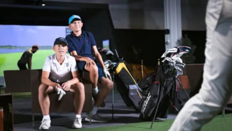 two players at virtual indoor golf center
