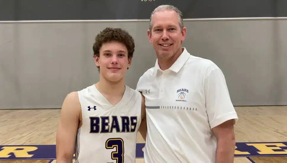 Colson Campbell (left) and father Jason Campbell (right) in front of basketball court