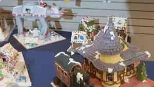a gingerbread display of houses in the shape of New Hope/Ivyland railroad landmark in front and a Star Wars AT-AT Walker