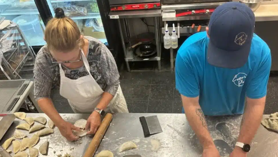 two people from above making pierogis at Dtown Cafe