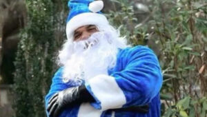 Morris Derry in blue santa suit as Homie Claus