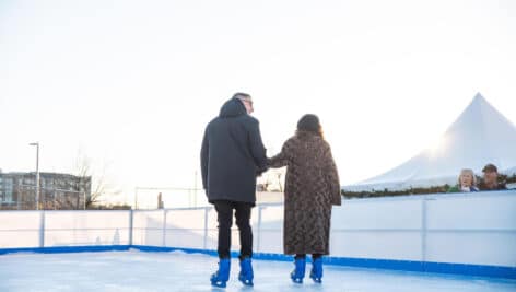 two people from behind silhouettes on Newtown Square ice rink