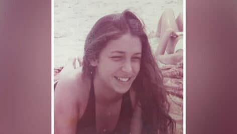 photo of Patty Bartlett smiling at the shore