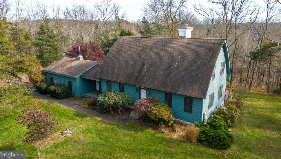 Exterior of blue traditional home resembling a barn in Pipersville