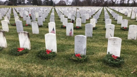 rows of grave stones with wreathes
