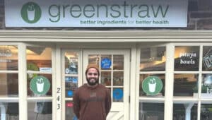 Dhruv Patel in front of Greenstraw business front