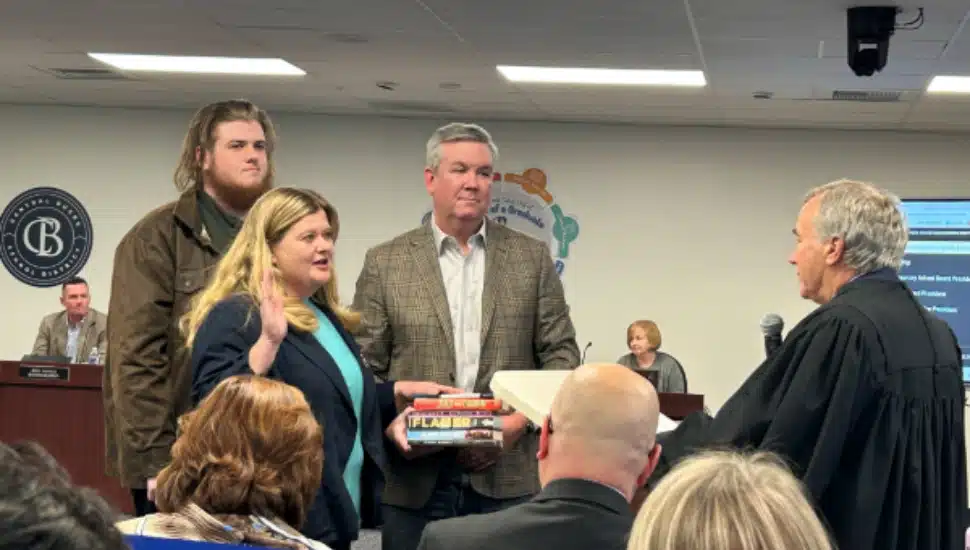 Karen Smith swearing in on banned books son to left and husband to right
