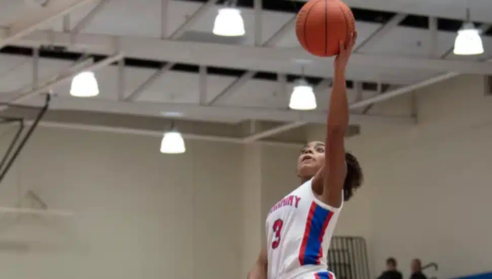 Alena Cofield mid-air shooting a hoop