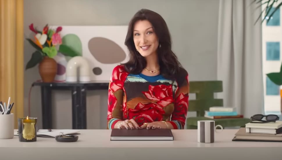 Bella Hadid sitting at desk in studio