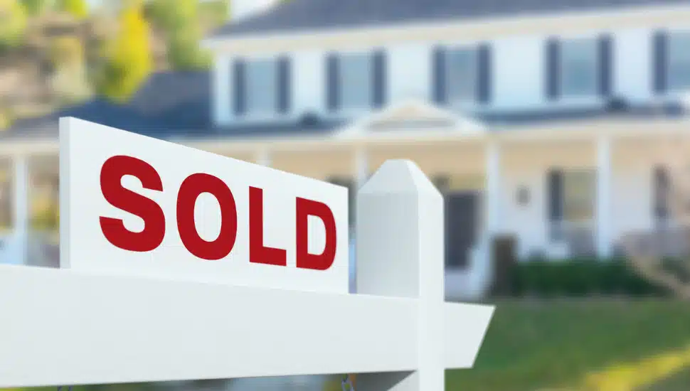Sold For Sale Real Estate Sign in Front of New House.