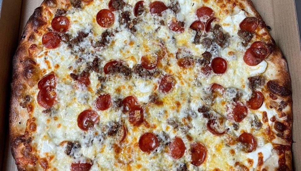 A large pizza with cheese and pepperoni.
