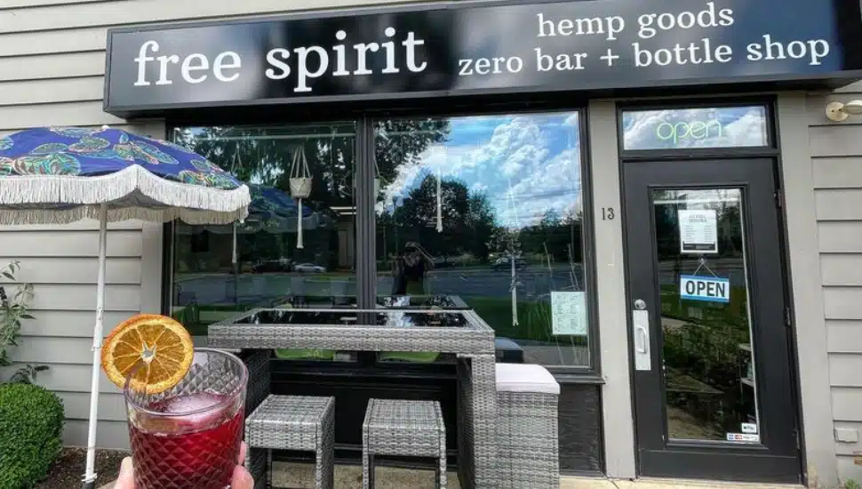 person holding mocktail in front of Free Spirit bar