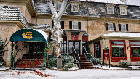 exterior of Golden Plough Inn on a snowy day