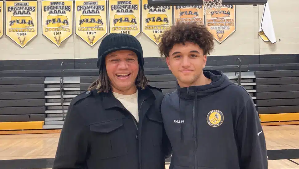 Thomas Phillips (left) and Julian Phillips (right) standing on basketball court.