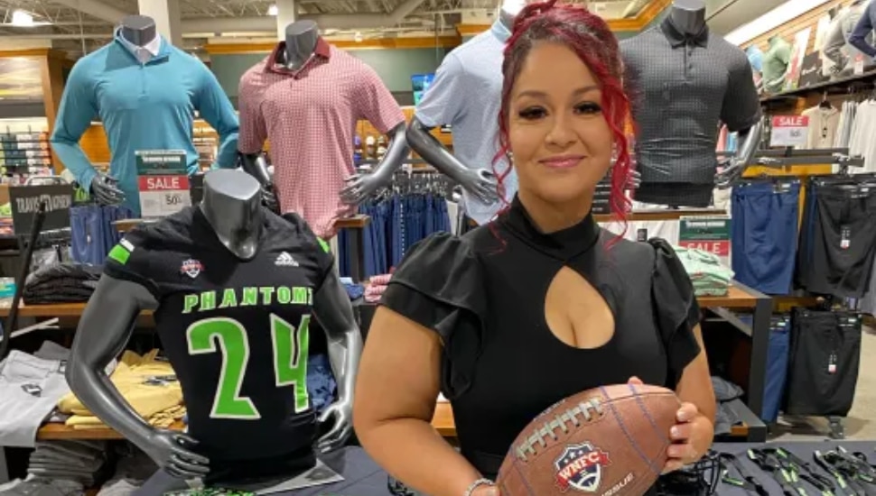 Maggie Bermudez holding football at Dick's Sporting Goods