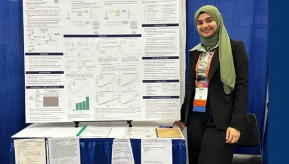 Maryam Abdel-Azim standing next to her presentation