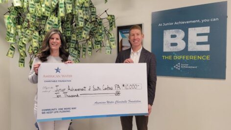 Pennsylvania American Water President Justin Ladner presents 2023 Workforce Readiness and STEM Education Grant check to Junior Achievement of South Central Pennsylvania Chief Operation Officer Allison Kierce.