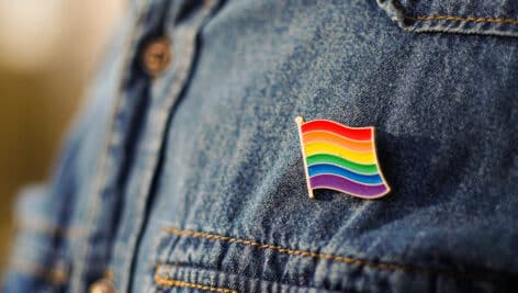 rainbow flag lapel pin on denim jacket