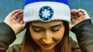 woman looking down wearing hot with coldest night symbol on it