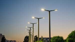 A modern street LED lighting pole. Urban electro-energy technologies. A row of street lights against the night sky.