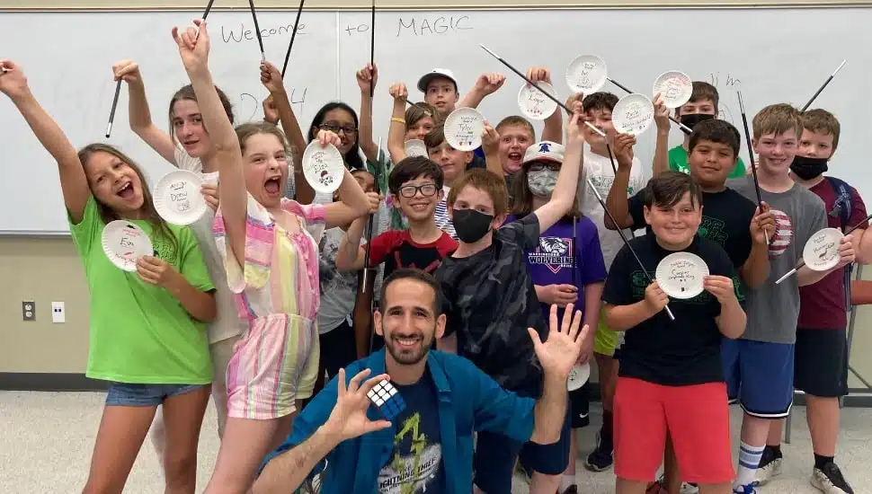 group pic of camp attendees and counselor holding arts and craft Delaware Valley University