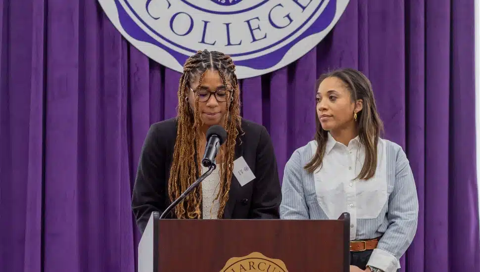 Erin and Kristen Gold at podium at Harcum College