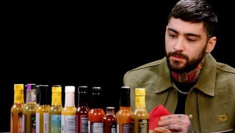 Zayn Malik with hot sauce on hot ones