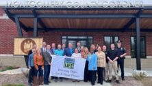 people standing outside of Montgomery County office with Donate Life flag