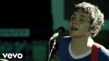 The Starting Line lead singer performing in front of microphone in music video