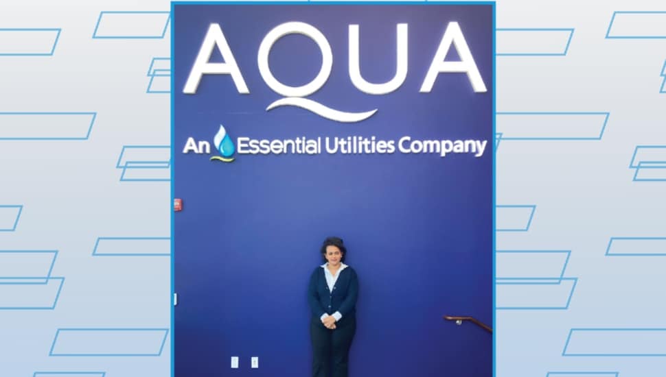 Nuhamin Getachew Gebremariam standing in front of Aqua backdrop