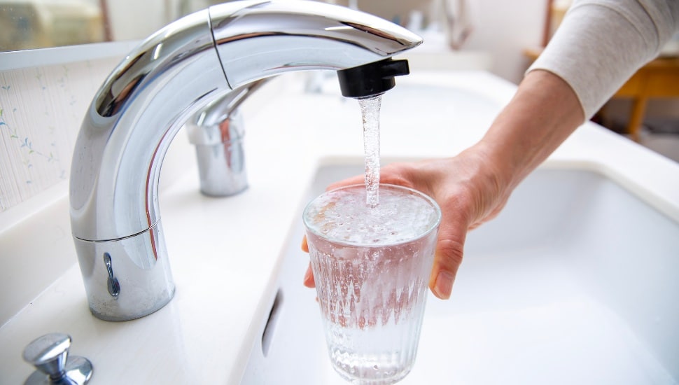 pouring tap water into a glass