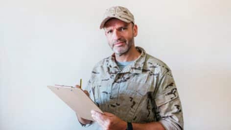 A man in uniform with a notepad