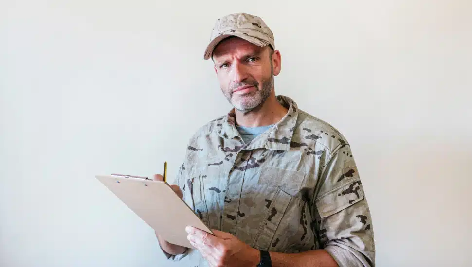 A man in uniform with a notepad