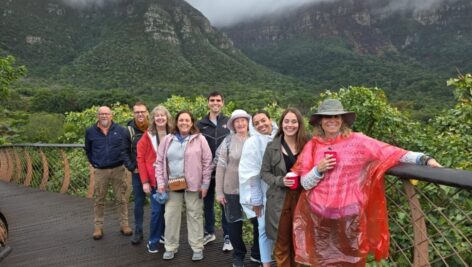 Holy Family University travel group gathered in front of a tour site in South Africa.