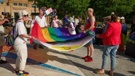 people at pride holding flag