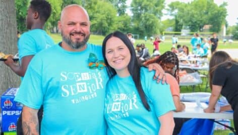 parents of Sophia wearing T-shirts that say Sophia's Senior Tailgate