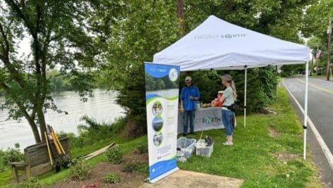 Spearhead Global volunteer tent on bank of Delaware River