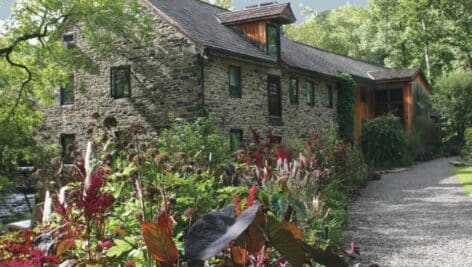 the gardens at mill fleurs house with garden foliage