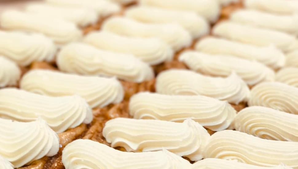 eclairs on a sheet waiting to be sold.