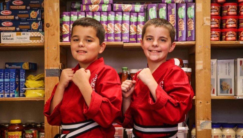 twins posing in karate uniforms