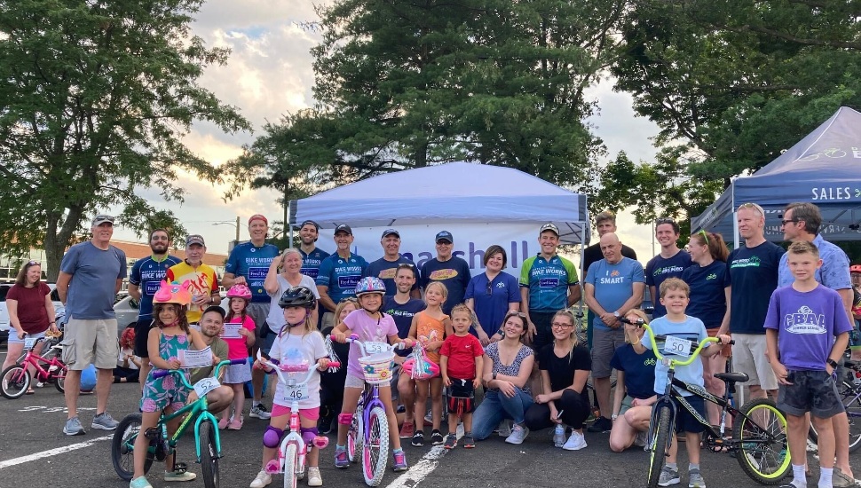 group of kids on bikes at Wheelie Wednesdays with tents and trees