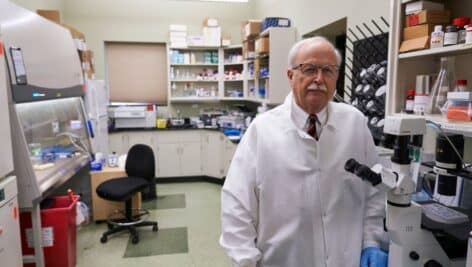 man in white lab coat in lab