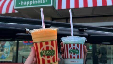 Two hands holding Rita's Italian Ice