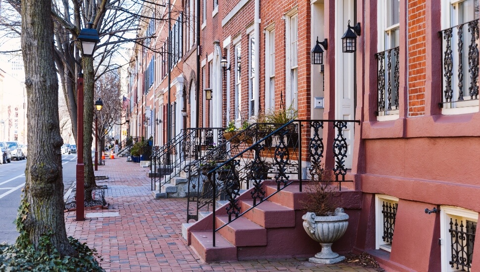 Rows of brownstone apartment buildings in Center City with windows, stoops and planters